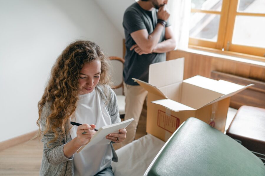 Couple packing and making an inventory list for their move